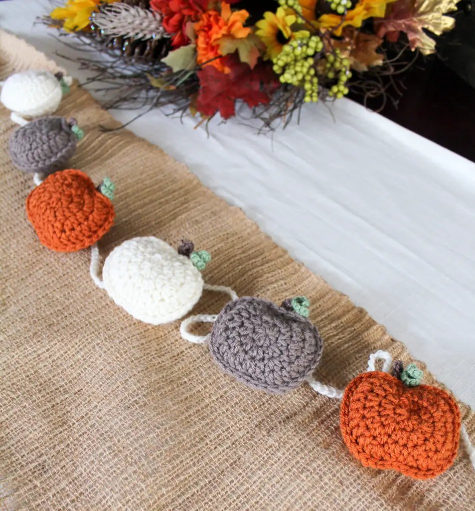 Space pumpkins at even intervals to create crochet pumpkin garland.