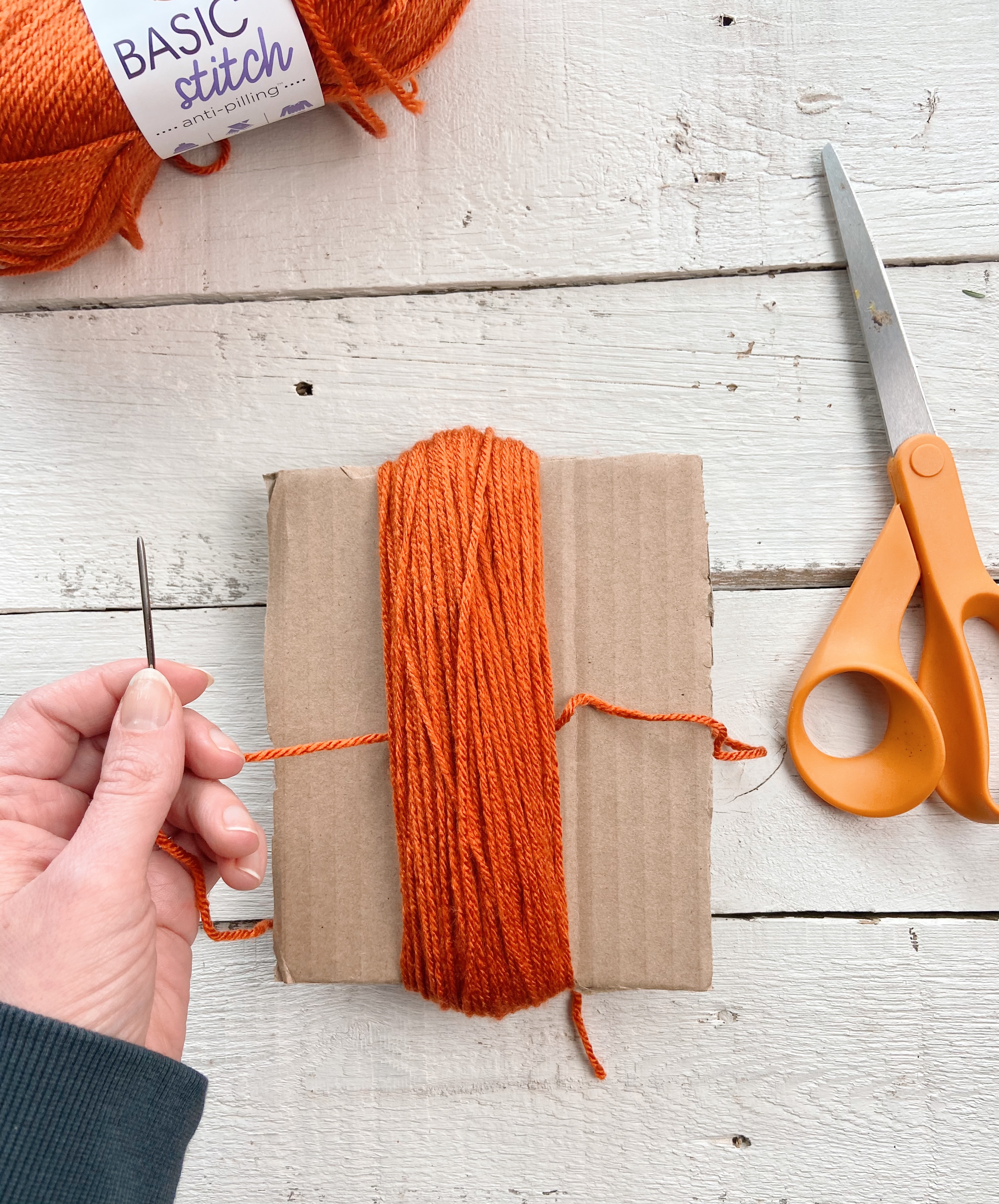 Thread needle behind yarn bundle