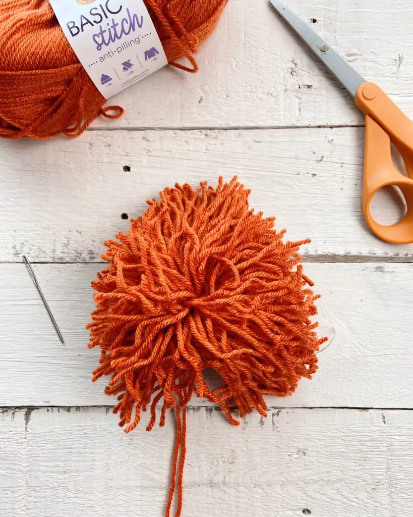 How to Make a Yarn Pom-Pom without it Falling Apart - Repeat Crafter Me